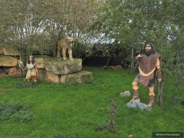 A visitor stands beside the landscaped animal enclosure.