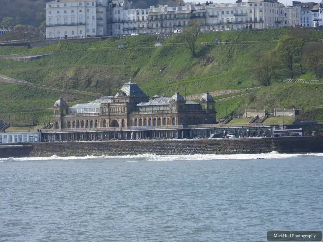 Scarborough Spa stands beside the water, with waves breaking along the seawall.