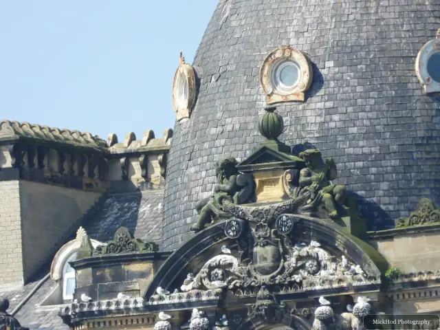 Sculpted figures and curved slate roofing decorate the upper façade of the Grand Hotel.
