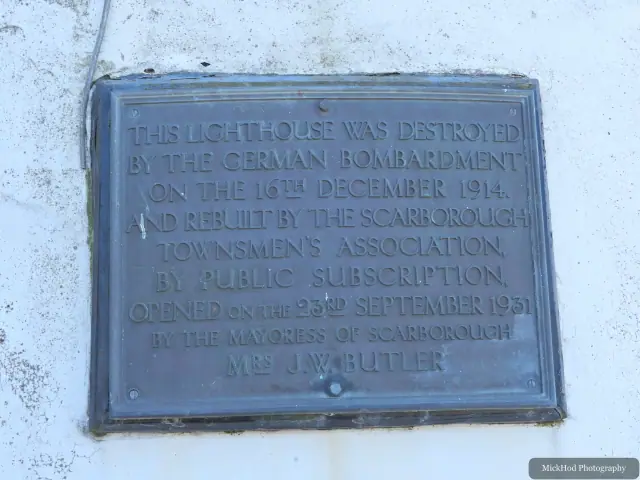 A plaque records that Scarborough Lighthouse was destroyed in the 1914 bombardment and later rebuilt.